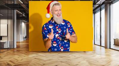 Portrait of modern stylish santa point fingers you new year xmas print shirt isolated on yellow color background Wall mural