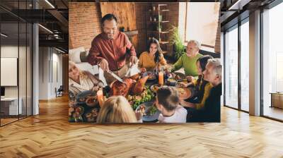 Portrait of nice attractive cheerful family brother sister parents grandparents multi generation enjoying festal meal occasion cutting turkey at modern loft brick industrial interior indoors Wall mural