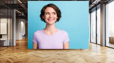 Portrait of nice lovely girl look toothy smile copyspace wear casual style outfit isolated over blue color background Wall mural