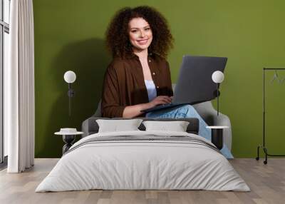 Portrait of nice young girl sit chair use laptop wear brown shirt isolated on khaki color background Wall mural