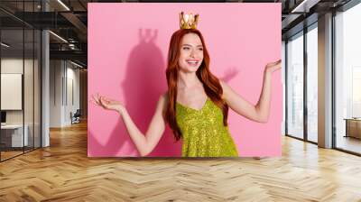 Portrait of nice young lady golden crown hold empty space wear shiny top isolated on pink color background Wall mural