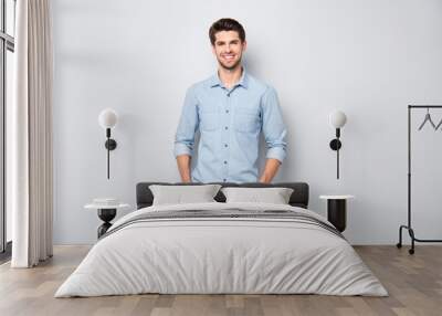 Portrait of positive cheerful dreamy emotions man have fun free time with his colleagues after work put hands pockets wear casual style clothing isolated over grey color background Wall mural