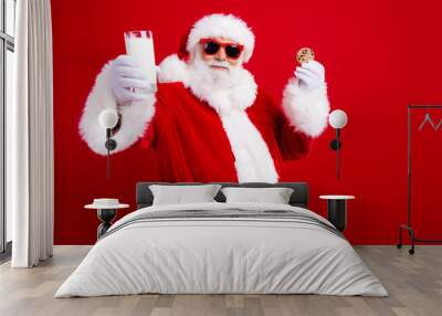 Portrait of positive santa claus arms hold milk glass chocolate new year cookie empty space isolated on red color background Wall mural