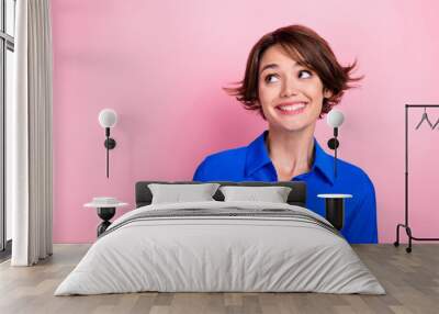 Portrait of pretty cheerful lady beaming smile look interested empty space isolated on pink color background Wall mural