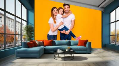 Portrait of three nice attractive charming cute lovely kind cheerful cheery funny carefree person cuddling embracing spending day life isolated over bright vivid shine yellow background Wall mural