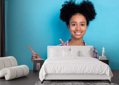 Portrait of toothy beaming person with perming coiffure wear plaid shirt indicating at offer empty space isolated on blue color background Wall mural