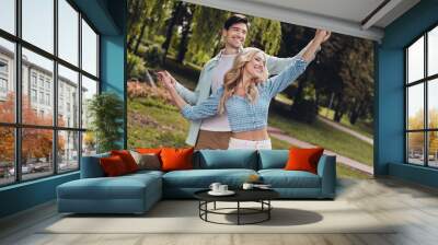 Portrait of two attractive cheerful carefree couple dancing enjoying weekend daydream on fresh air outdoors Wall mural