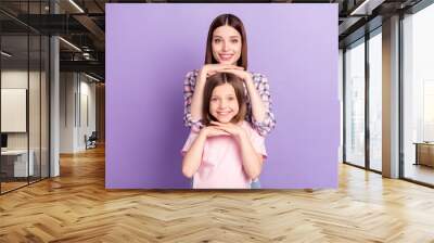 Portrait of two attractive cheerful careful girls posing mom daughter isolated over purple violet color background Wall mural