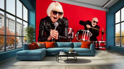 Portrait of two retired pensioner retired people woman sing composition solo man play drum drumstick enjoy leisure night club event wear leather isolated over bright shine color background Wall mural