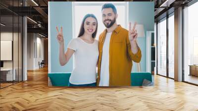 Portrait of two young people show v-sign weekend pastime modern interior flat indoors Wall mural