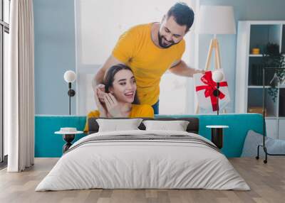 Portrait of two young people surprise giftbox weekend pastime modern interior flat indoors Wall mural