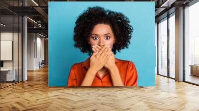 Portrait of worried nervous lady arms palms covering mouth mute quiet isolated on blue color background Wall mural