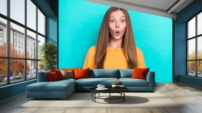 Portrait of young funny shocked lady pouted lips surprise good news her school holidays begin earlier isolated on aquamarine color background Wall mural