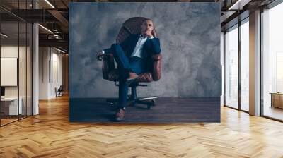 Portrait serious stunning agent economist sit furniture manager representative manager brown dream dreamy touch chin short hair bald cross legs satisfied modern jacket isolated dark background Wall mural