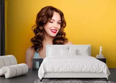 Portrait with copyspace empty place of foxy funny girl with modern hairdo winking with one eye having beaming smile red pomade lipstick isolated on yellow background Wall mural