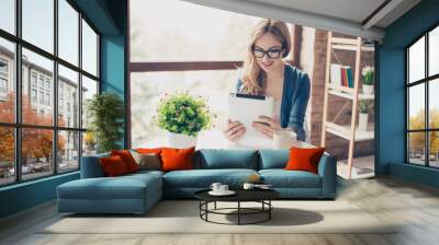 pretty young smiling woman using digital tablet and having break in a cafe Wall mural