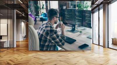 Profile portrait of clever cybersecurity expert sitting chair hold tea mug look pc screen operating database open space workplace indoors Wall mural