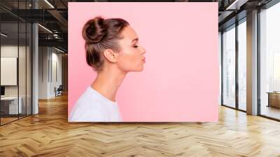 Profile side view portrait of her she nice cute attractive lovely sweet cheerful girl lady kissing you isolated over pastel pink background Wall mural