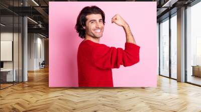 Profile side view portrait of nice cheerful content guy demonstrating strong arm isolated over pink pastel color background Wall mural