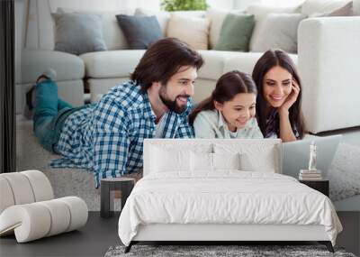 Profile side view portrait of nice cute lovely sweet charming attractive cheerful friendly people mommy daddy lying on floor carpet using wi-fi speed in light white modern interior indoors Wall mural