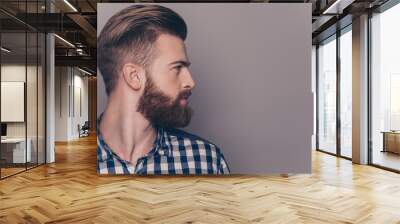 Side view portrait of thinking stylish young man looking away Wall mural