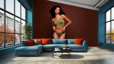 Studio no retouch photo of positive adorable lady dressed lingerie enjoying perfect shape empty space isolated brown color background Wall mural