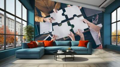 Top above high angle view photo of focused freelancer people sit table desk merge paper puzzle pieces elements trust support company career coaching concept in workstation workplace Wall mural