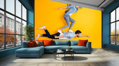 Top view above high angle flat lay flatlay lie full length body size view concept of his he her she beautiful handsome spouse flying isolated on bright vivid shine vibrant yellow color background Wall mural