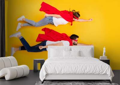 Top view above high angle flat lay flatlay lie view concept of her she his he strong successful superheros flying to rescue isolated on bright vivid shine vibrant yellow color background Wall mural