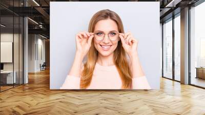 Try-on round old-fashioned people person concept. Close up portrait of cute charming gorgeous lovely clever confident pretty teen age girl touching thin rim-glasses isolated on gray background Wall mural