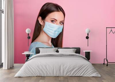 Turned close up photo of nice girl look in camera wear blue face mask isolated over pastel color background Wall mural