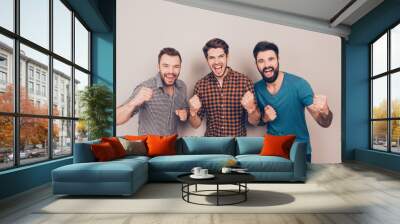 yeah! three handsome screaming men showing their strong hands Wall mural