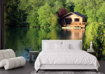 A wooden fishing lodge on the banks of a Cotswold leisure lake. UK. Wall mural