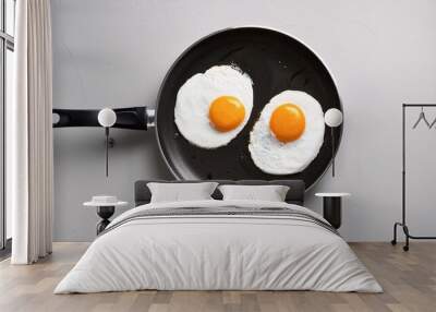 healthy quick breakfast made of two fried eggs on a table traditional simple food on a frying pan for eating top view Wall mural