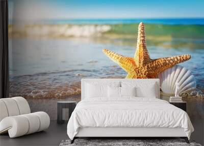 starfish and seashell on the summer beach in sea water Wall mural