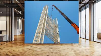 Man Working on the Working at height on construction site with blue sky Wall mural