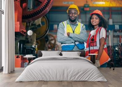 Portrait of professional happy smiling Black African American engineers, workers, technician man and woman wear hard hat, use clipboard discuss work in steel metal plant manufacturing factory industry Wall mural