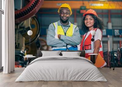 Portrait of professional happy smiling Black African American engineers, workers, technician man and woman wear hard hat, use clipboard discuss work in steel metal plant manufacturing factory industry Wall mural