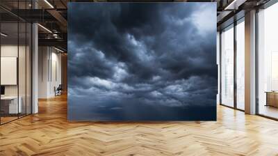 The dark sky had clouds gathered to the left and a strong storm before it rained.Bad weather sky. Wall mural