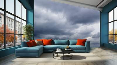 The dark sky with heavy clouds converging and a violent storm before the rain.Bad weather sky.. Wall mural