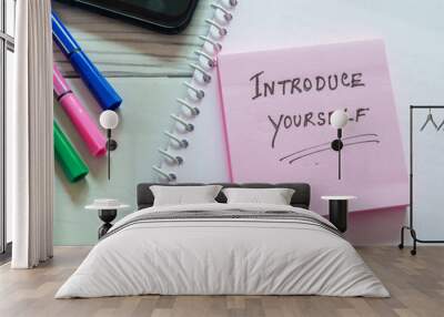 Sticky note with the text Introduce yourself on office desk. Self-introduction concept. Wall mural