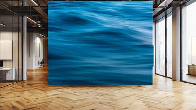 Gentle soothing silky flowing natural ocean water movement. Abstract background motion blur. Serene and peaceful deep blue sea in nature. Wall mural