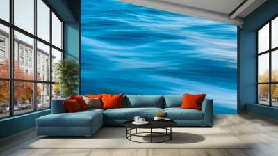 Gentle soothing silky flowing natural ocean water movement. Abstract background motion blur. Serene and peaceful deep blue sea in nature. Wall mural