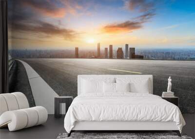 panoramic city skyline and buildings with empty asphalt road at sunset Wall mural