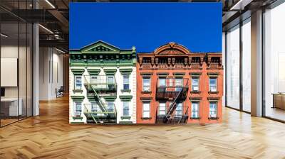 Old green and red apartment buildings with empty clear blue sky background in the Alphabet City neighborhood of Manhattan in New York City Wall mural