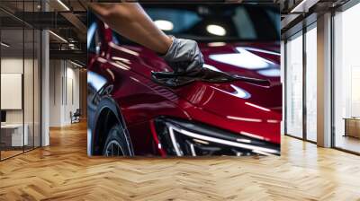 A man meticulously cleaning a car with a microfiber cloth Wall mural