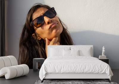 Young indian woman thinking and happy Wall mural