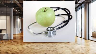 Medical stethoscope and green apple. Healty food Wall mural