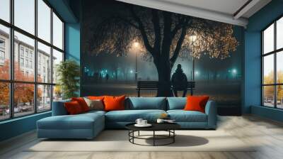 A lonely man sitting in the park at night, light mist, trees, dark, lamp post, cinematic Wall mural