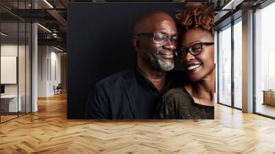 Portrait of happy black african american couple smiling and embracing each other on dark background Wall mural